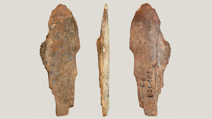 an ancient hide scraping tool shown at three different angles