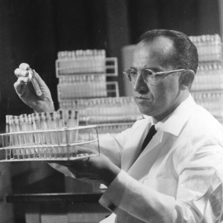 Salk holding a vial
