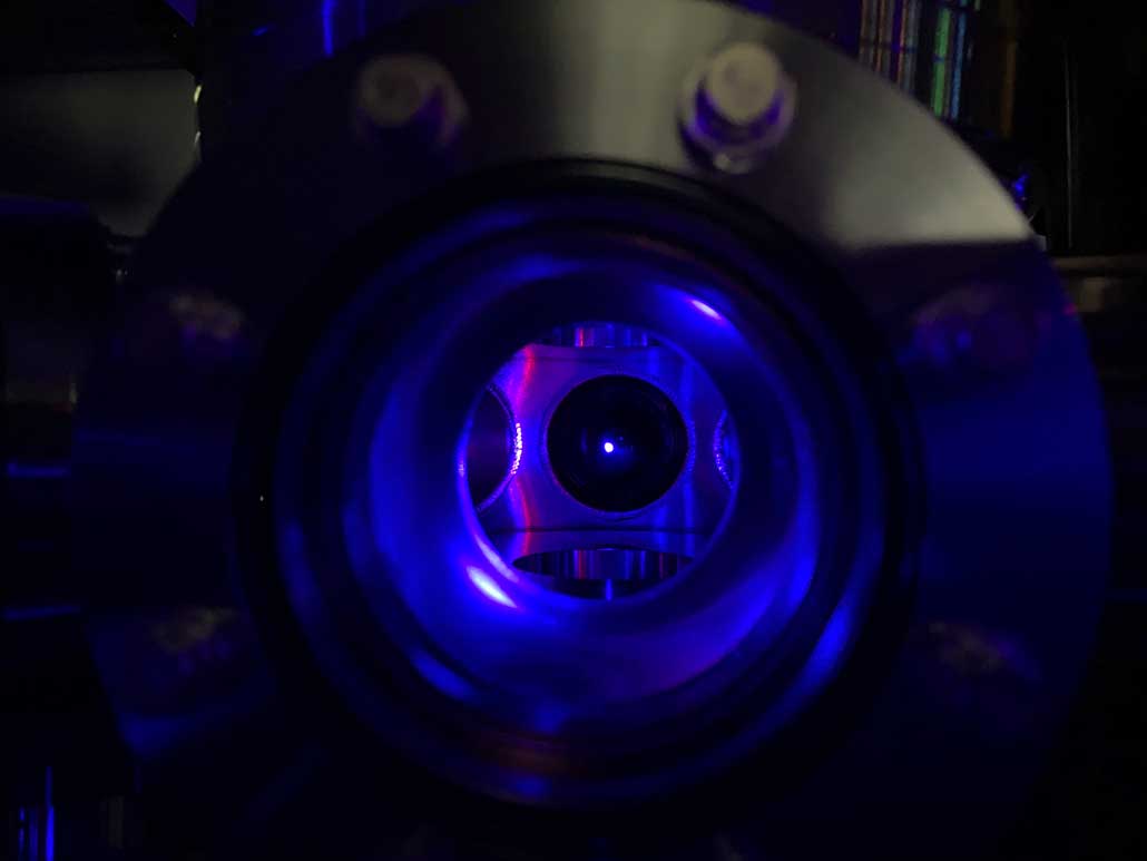 image of strontium atoms glowing blue in a vacuum chamber