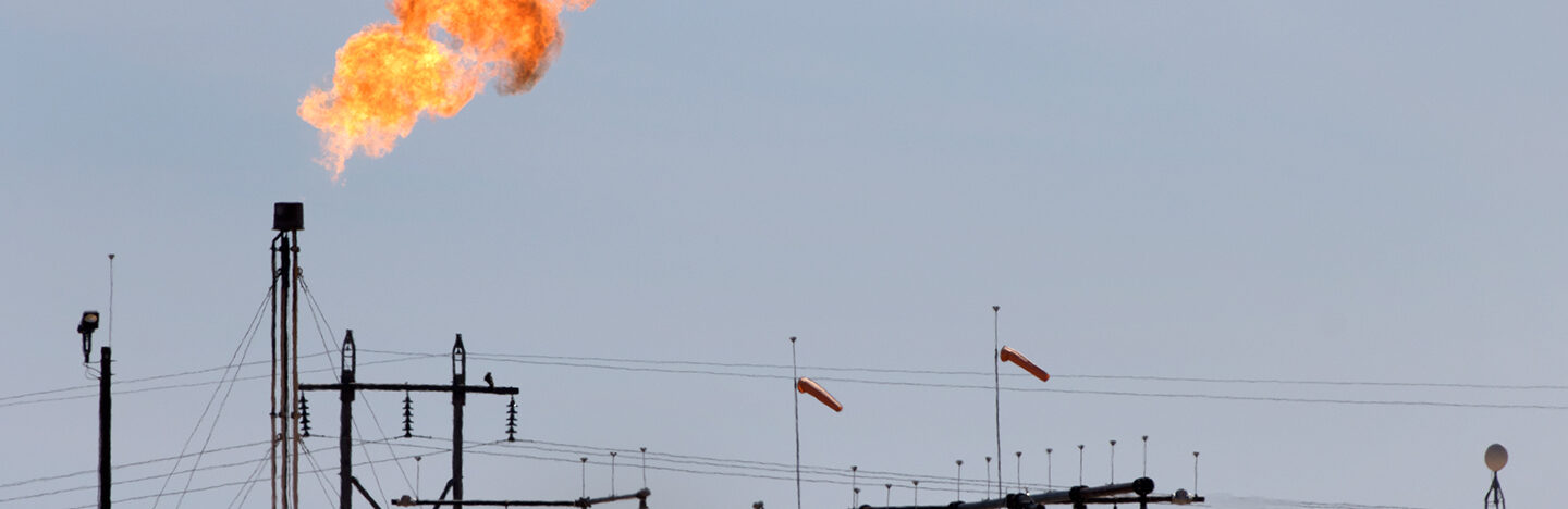 image of a flaming gas flare at an oil field in Texas