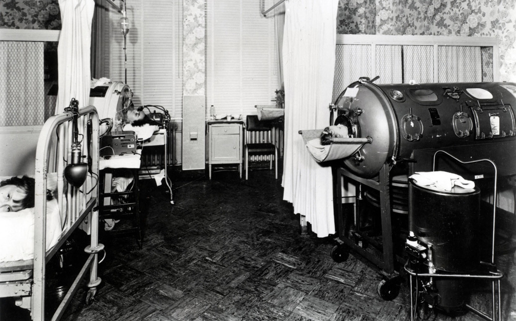 black and white photo of children inside an iron lung
