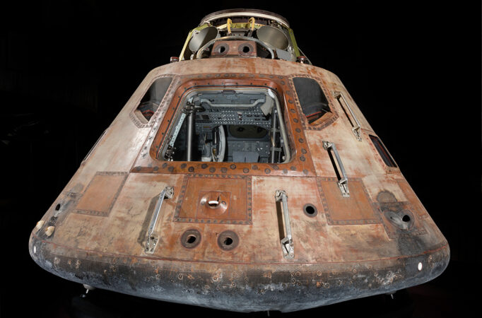 the rust-colored Apollo capsule on a black background