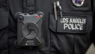 close-up image of a Los Angeles police officer wearing a body cam on their uniform