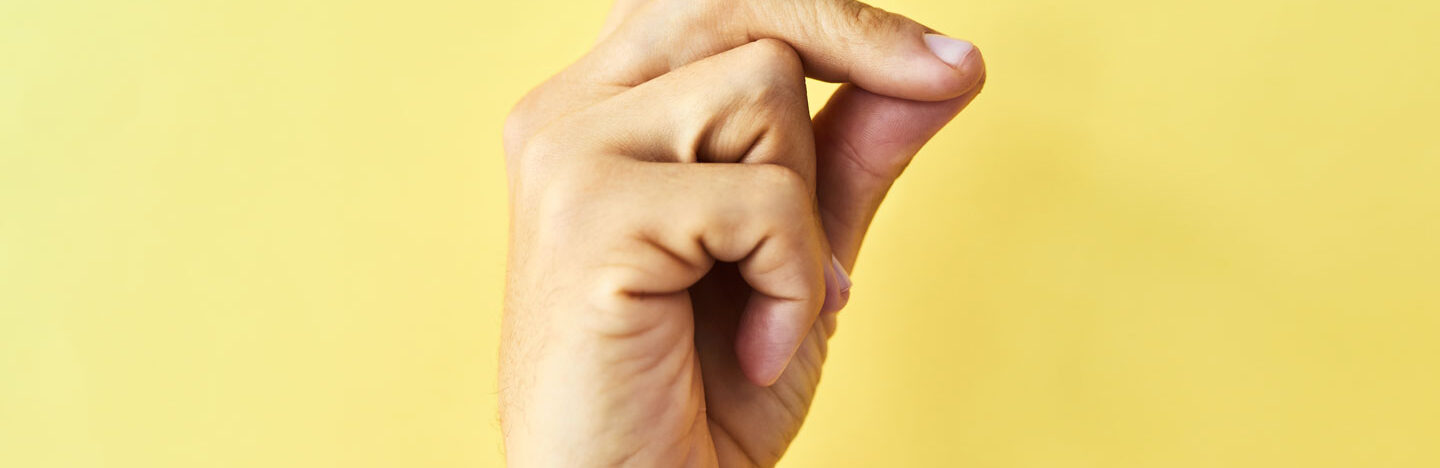 image of a hand snapping on a yellow backdrop