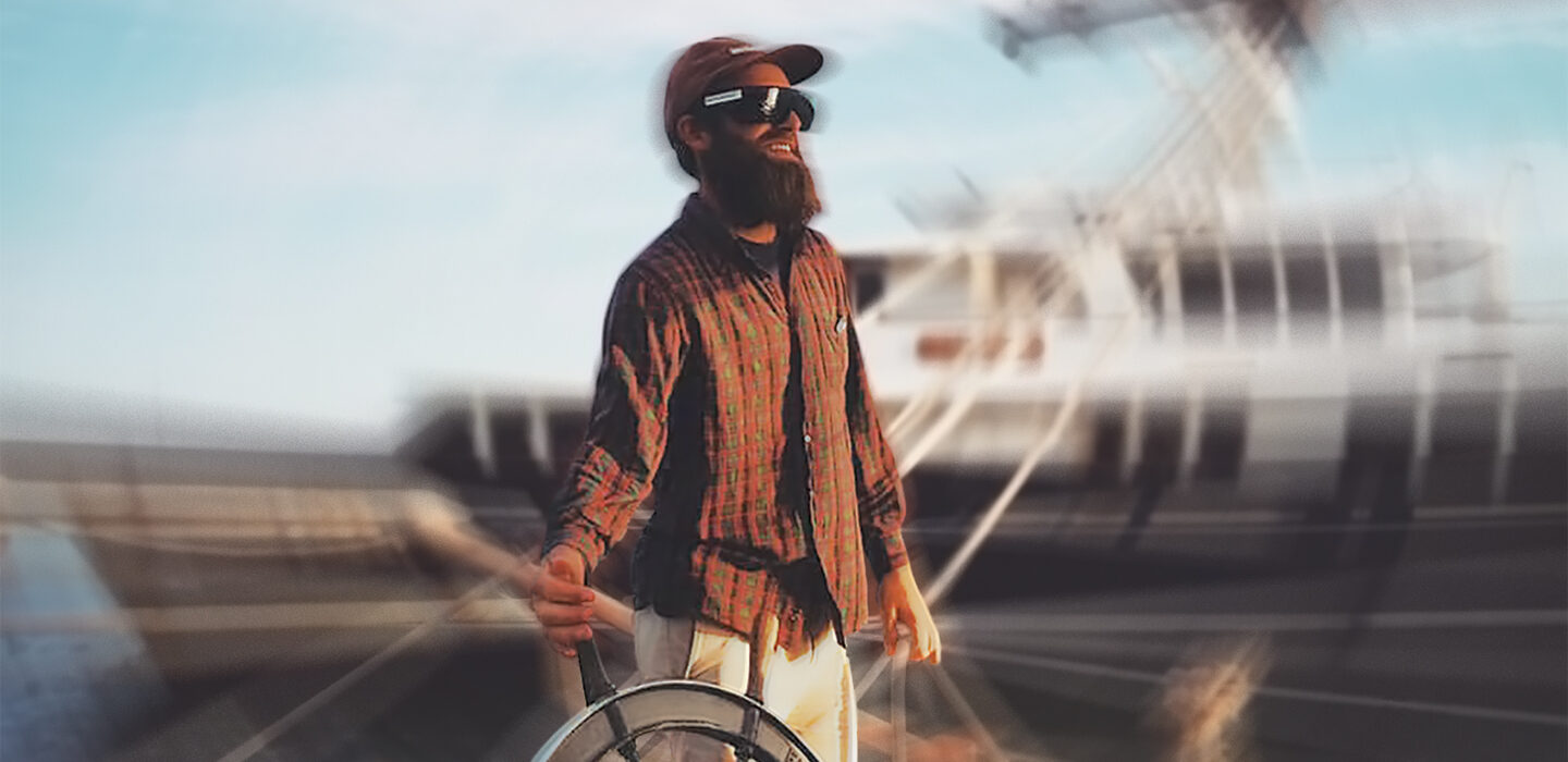 image of Tyson Bottenus holding the helm of a boat with a spin effect