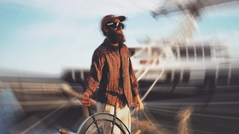 image of Tyson Bottenus holding the helm of a boat with a spin effect