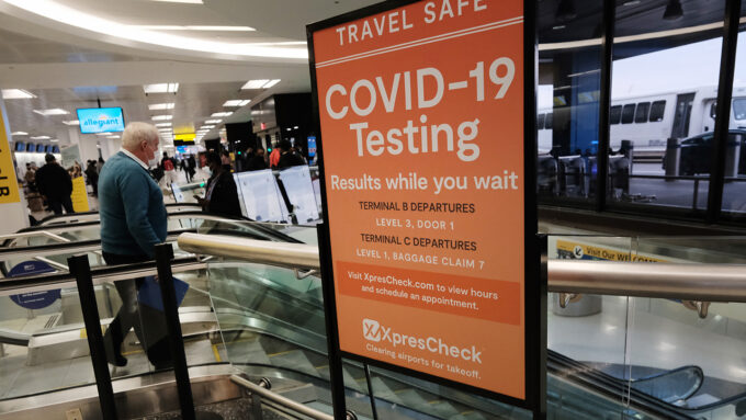 a sign advertising COVID-19 testing in an airport