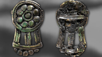 a bronze buckle shown from the front and back