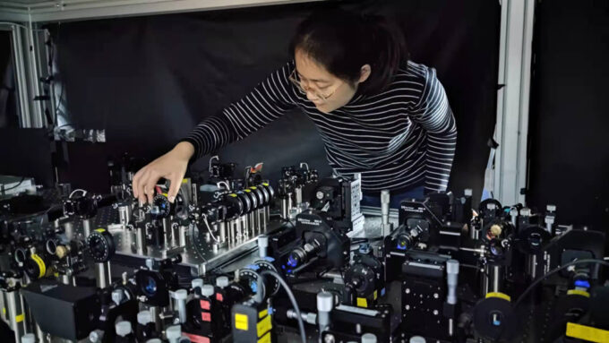 physicist Yali Mao working with highly technical physics apparatus