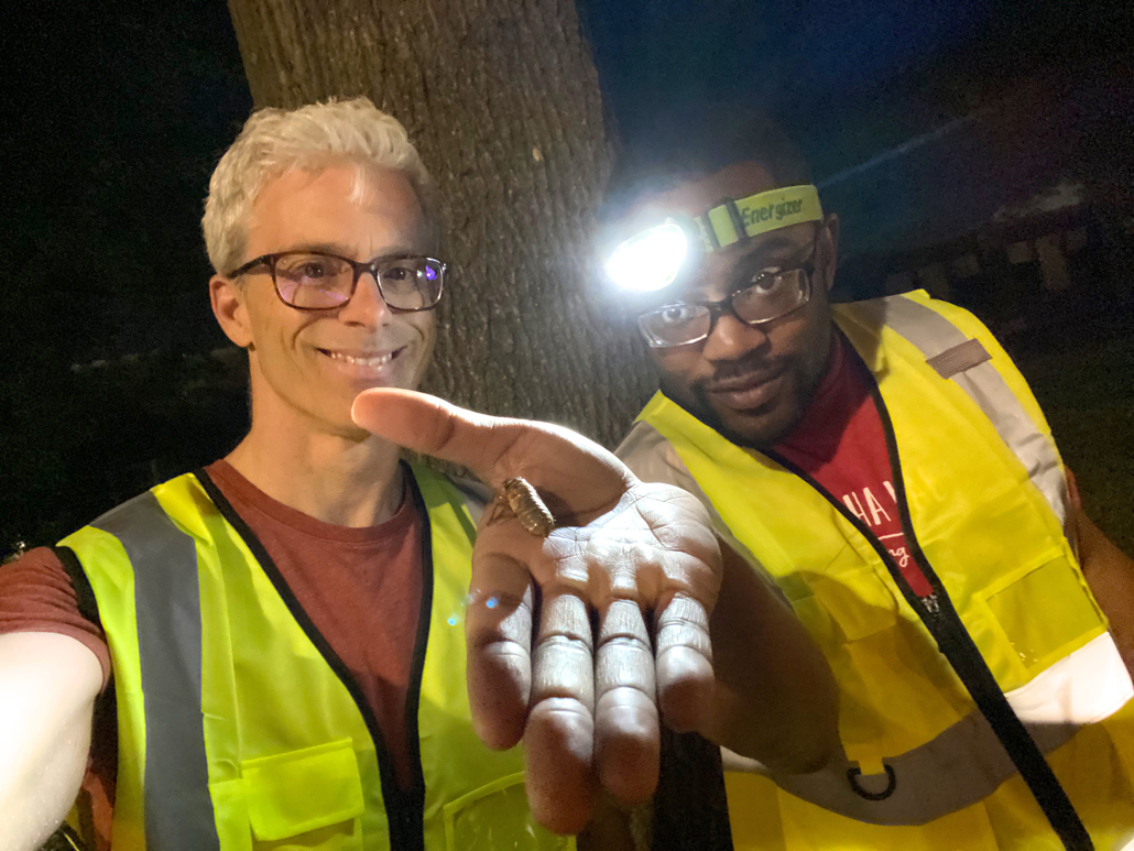 Researchers from Virginia Tech holding a cicada