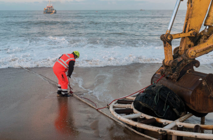 photo of a person working on Google’s Dunant subsea cable on the French coast