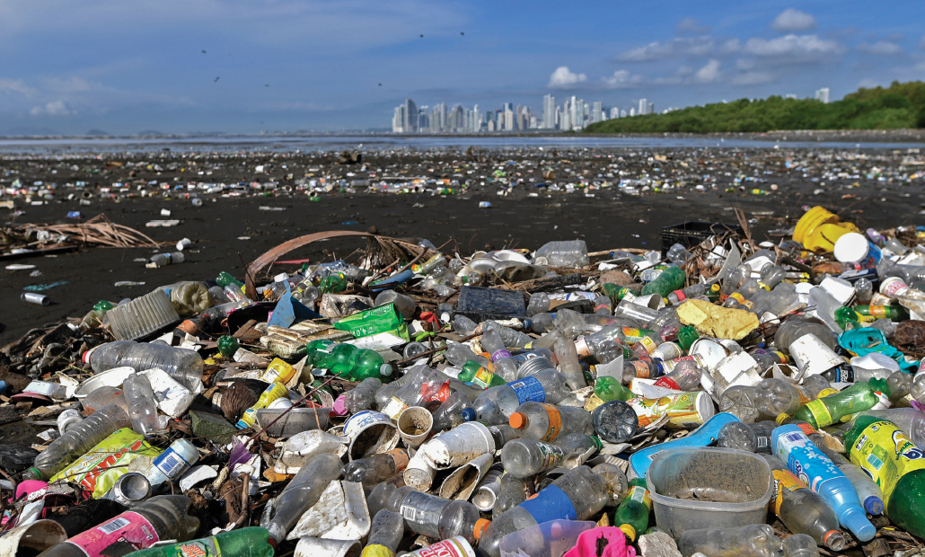 photo of piles of plastic on Costa del Este beach with Panama City in the background