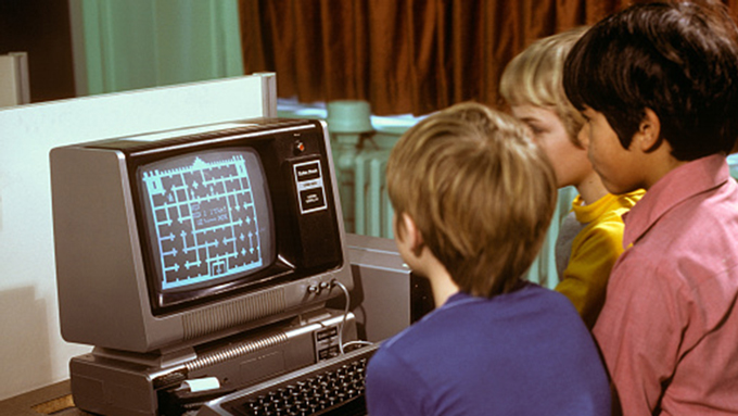 Kids looking at a computer