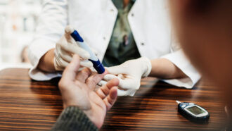 photo of someone pricking a finger to test blood sugar levels