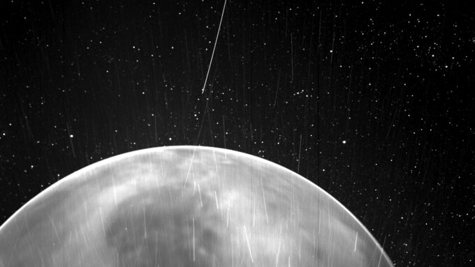 a grayscale photo of the surface of Venus against a backdrop of stars