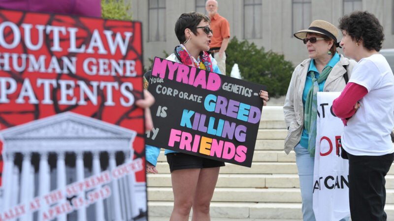 protesters hold posters outside the U.S. Supreme Court
