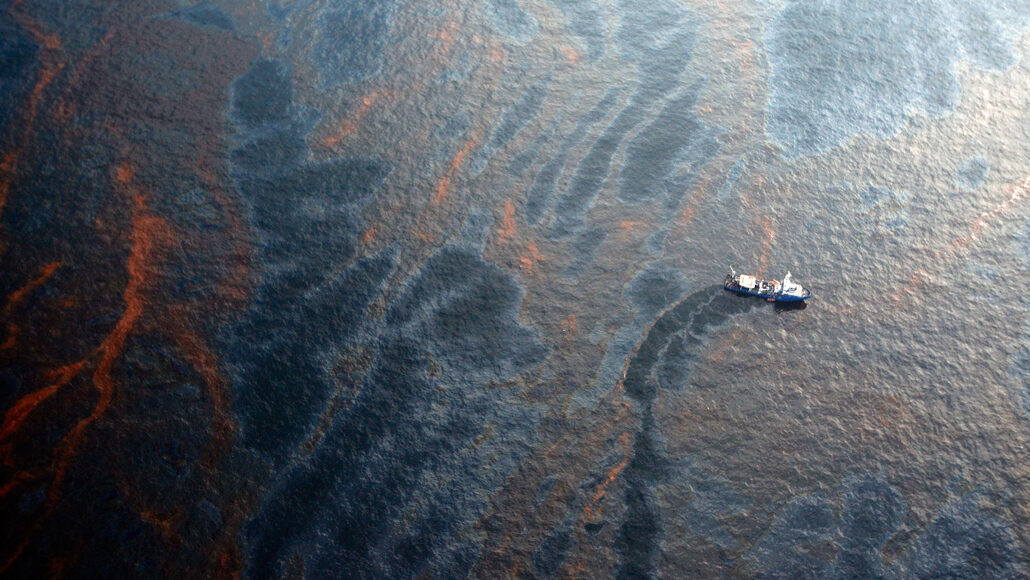 aerial photo of a U.S. Coast Guard boat collecting spilled oil from Deepwater Horizon