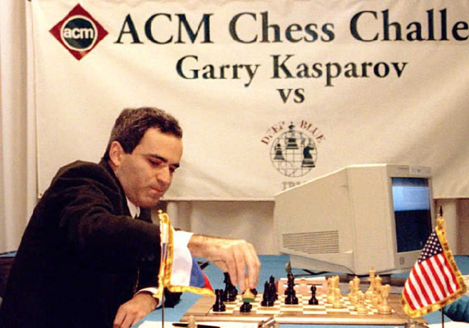 photo of Garry Kasparov moving a piece on a chess board during the match against Deep Blue