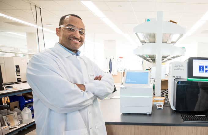 photo of Tshaka Cunningham standing in a lab