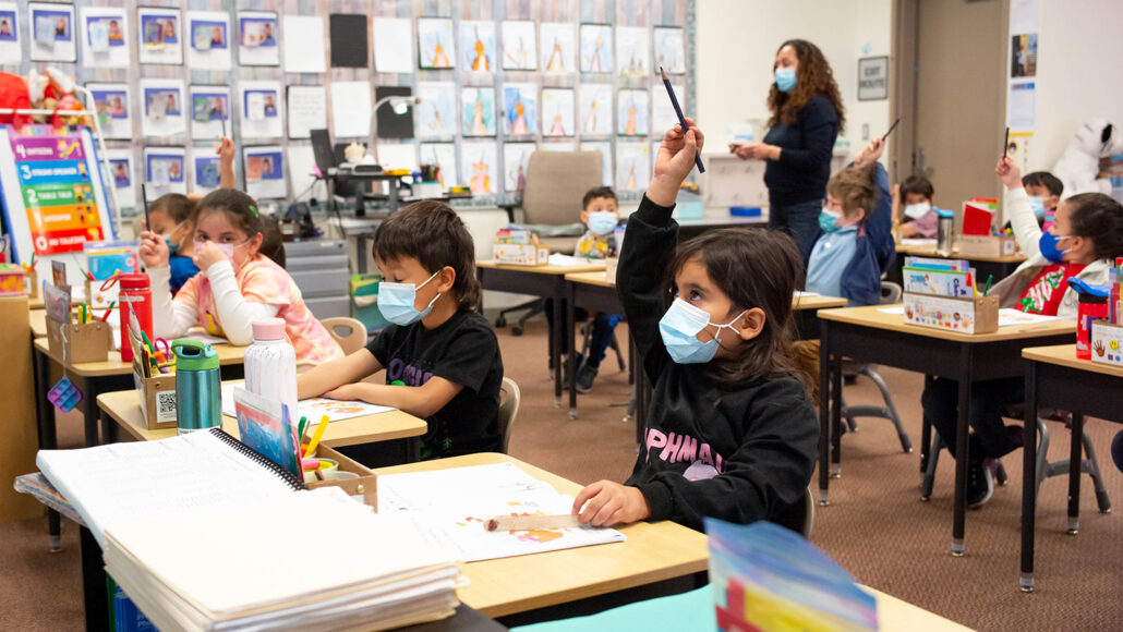kindergartners in a classroom, wearing masks