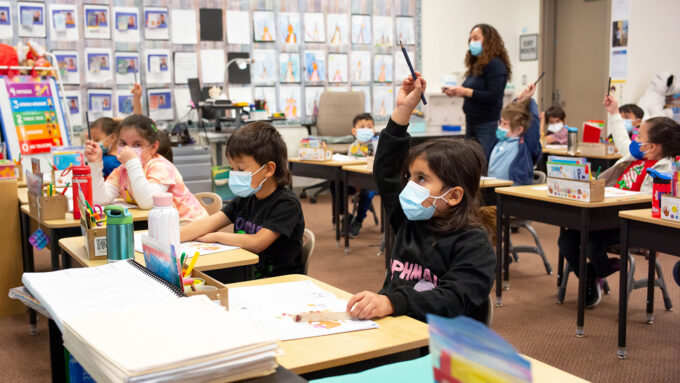 kindergartners in a classroom, wearing masks