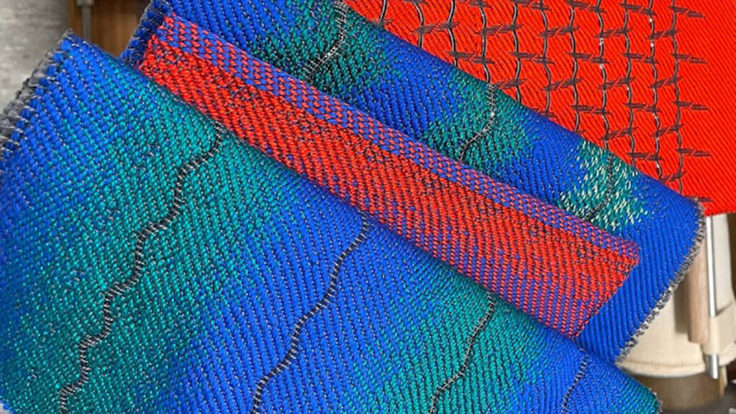 image of experimental fabric made of woven blue, green and red thread