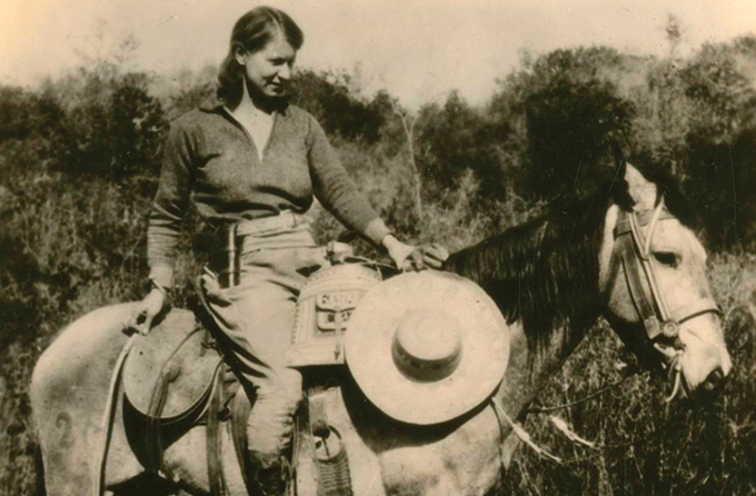 black and white image of Emma Reh on a horse