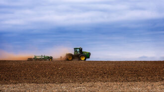 photo of a tractor tilling a field