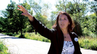 Lois Gibbs gestures as she leads a tour of Love Canal in 2008