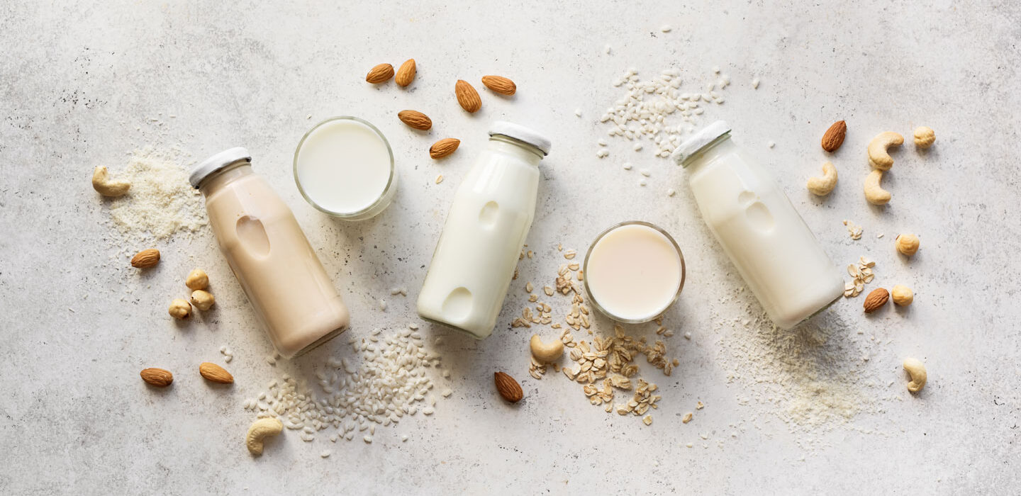 a photo of several bottle of plant milks on a table