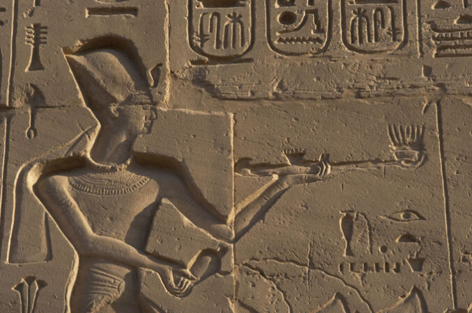 wall carving showing pharaoh Ramses II holding an incense burner