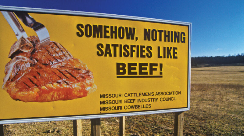 Billboard saying "Somehow, nothing satisfies like beef!"