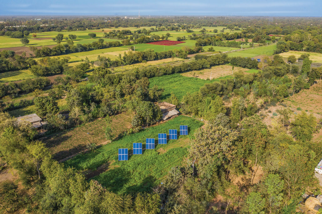 an aerial image of solar panels among crops