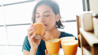 woman smelling a candle