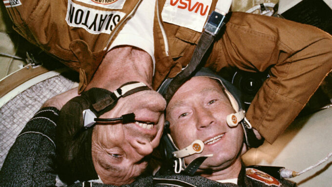 Astronaut Donald Slayton embraces cosmonaut Aleksey Leonov