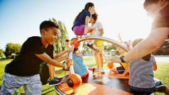 young kids playing on playground equipment