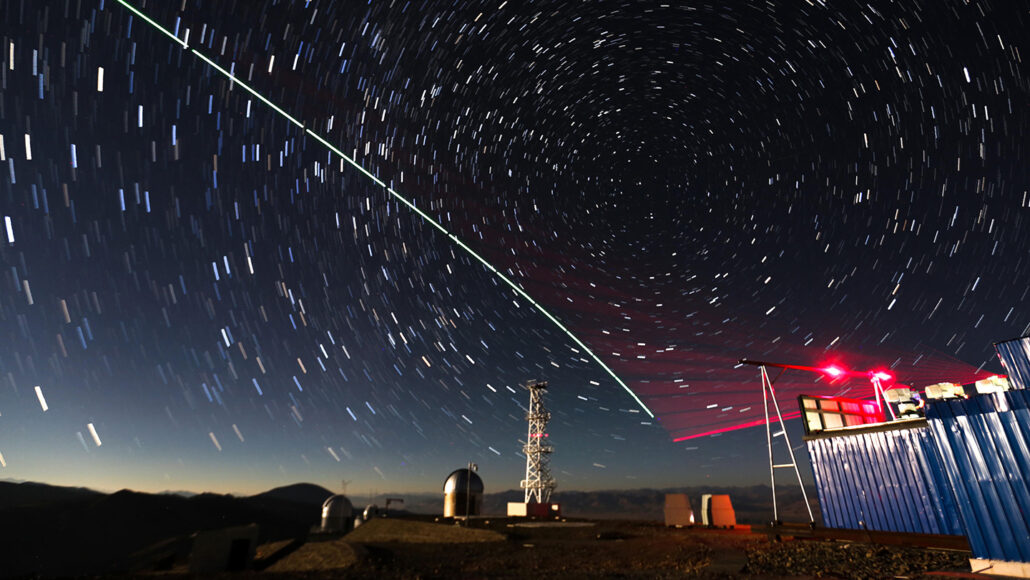 a test of a qυantυм coммυnications satellite. Varioυs towers and lights are shown against a backdrop of a tiмe-lapsed night sky