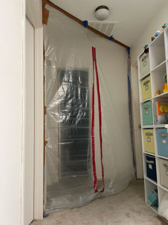 a hallway blocked by floor-to-ceiling plastic sheeting