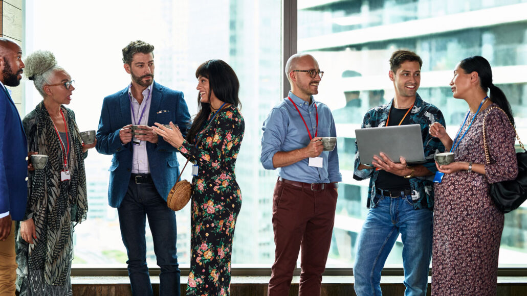 a group of people talking in a corporate office setting