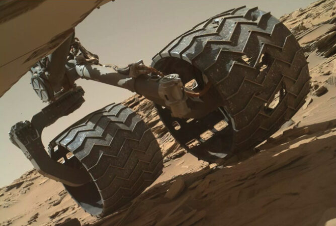 photo showing holes in two of Curiosity's wheels