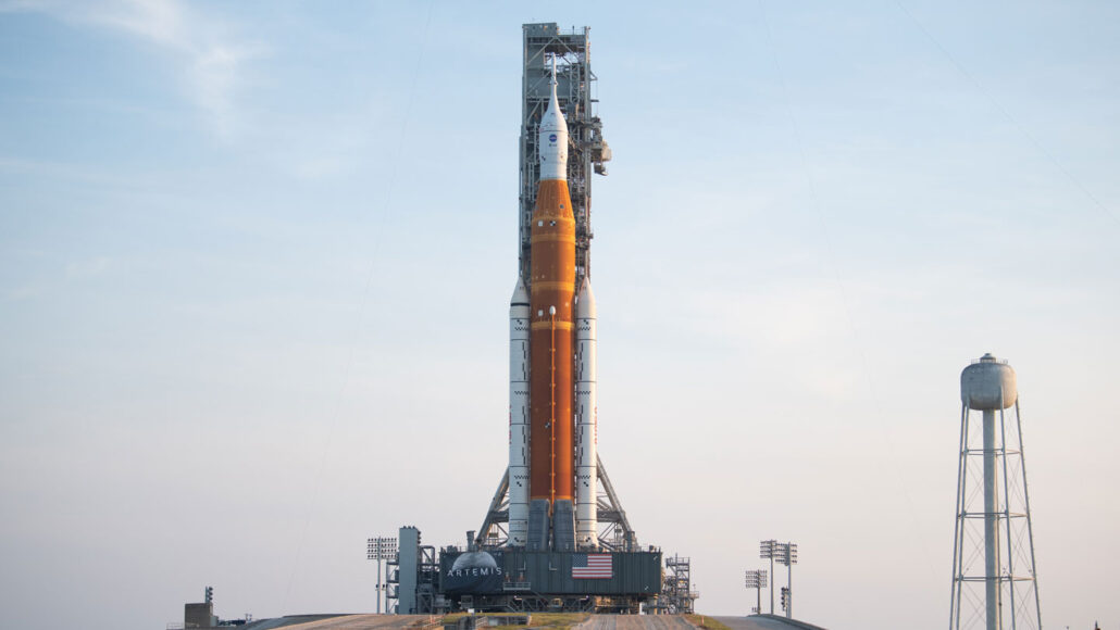 NASA’s Space Launch System rocket and the Orion spacecraft preparing to launch against a hazy sky