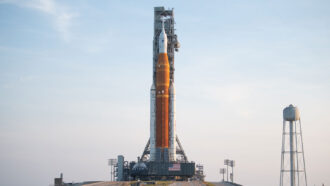 NASA’s Space Launch System rocket and the Orion spacecraft preparing to launch against a hazy sky