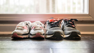 image of two pairs of sneakers by a door