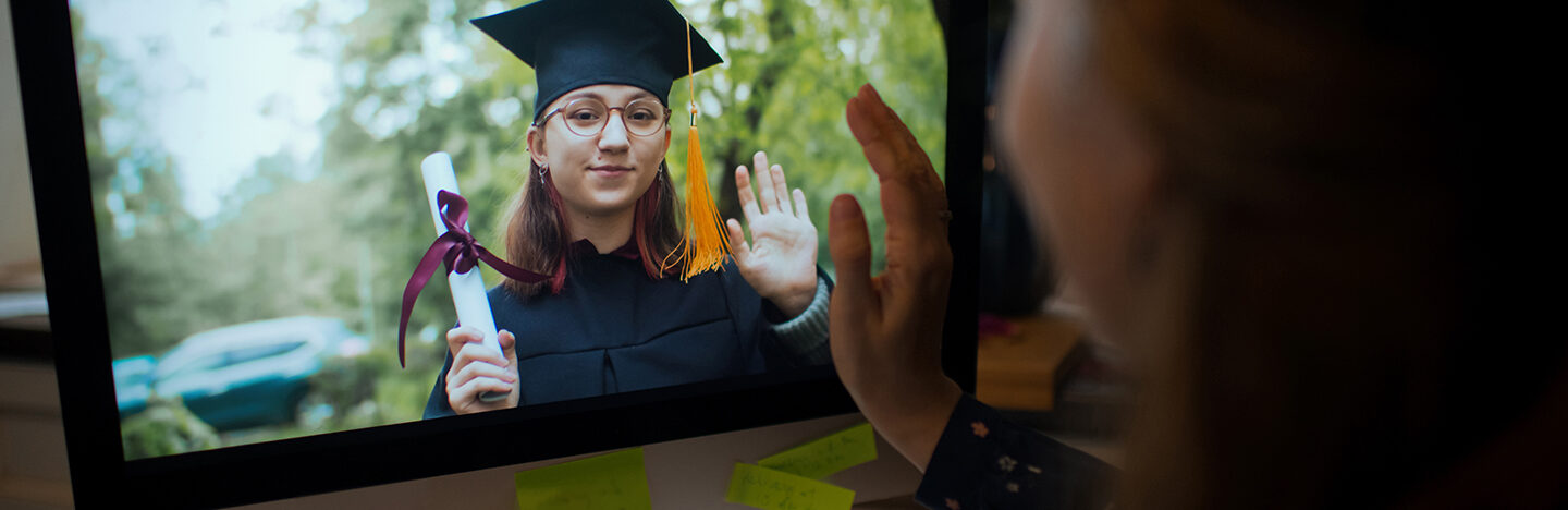 image of someone watching a woman graduate on a video call