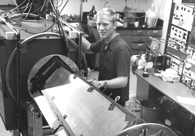 black and white image of John Clauser at work in a laboratory
