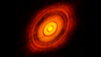 Orange planet-building disk of gas and dust in space