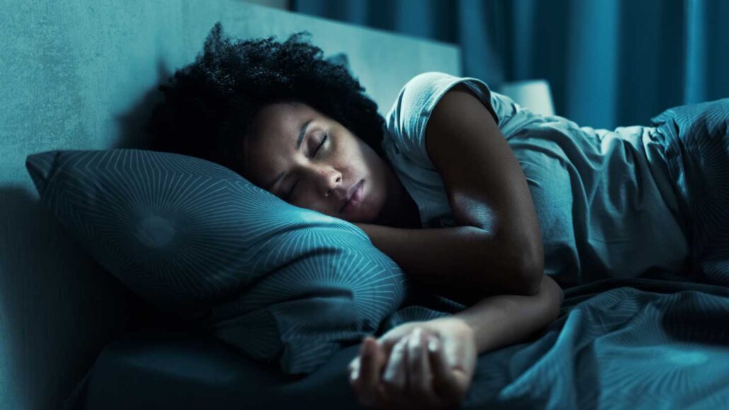 A photo of a women asleep in a bed