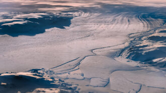 An aerial photo of the Nioghalvfjerdsfjord glacier