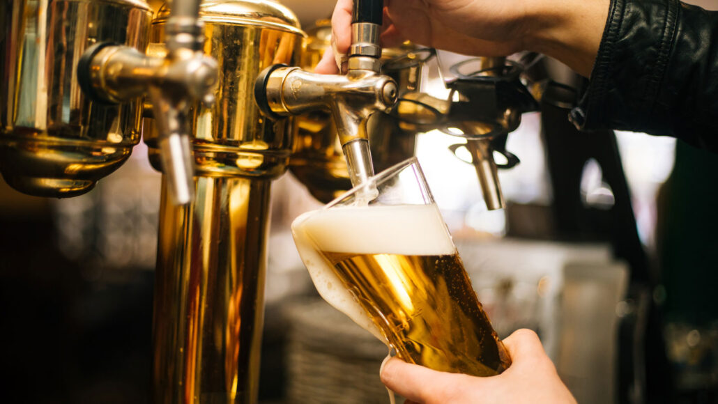 photo of someone pulling a pint of beer