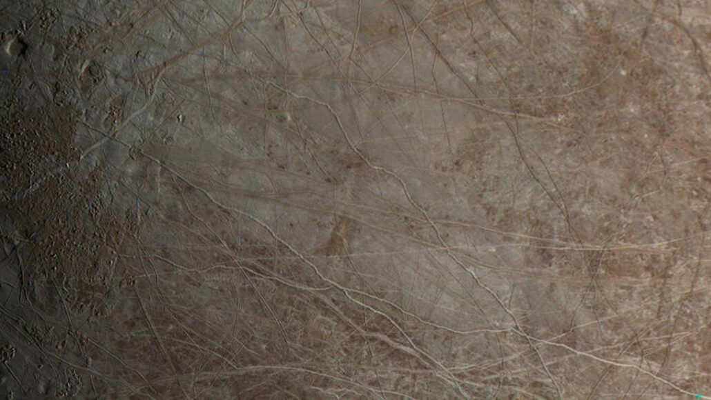 The surface of Jupiter's moon Europa, showing cracks and ridges in the ice